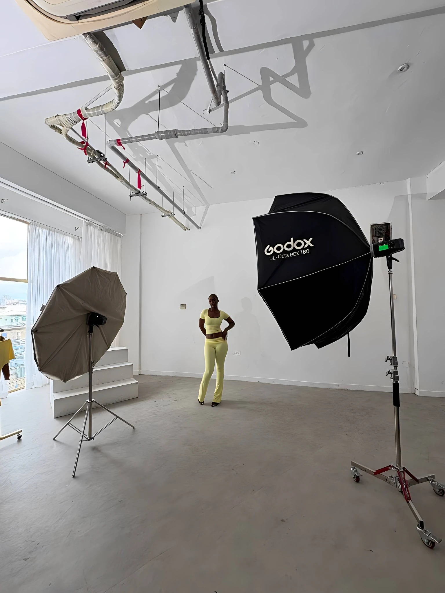Behind the scenes at a Creative Pie shoot: a model between studio lights